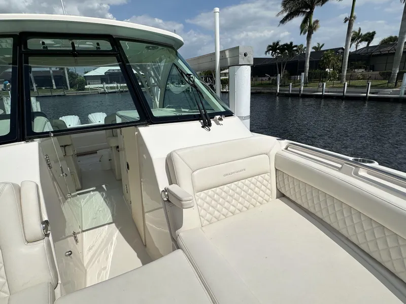 Slide: The Image of 2023 Grady-White Freedom 325 boat interior with luxurious seating by the water. - 5