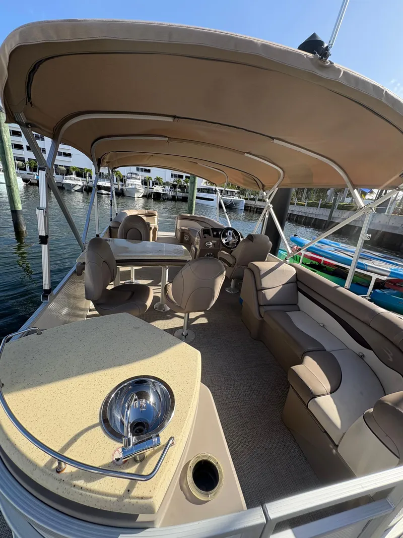 Slide: The Image of 2019 Bennington ETW pontoon boat with spacious seating and canopy, docked at marina. - 3