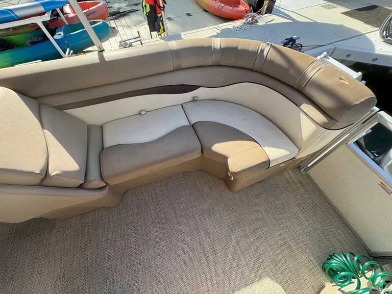 Slide: The Image of 2019 Bennington ETW boat interior with beige seating and carpeted floor. - 4