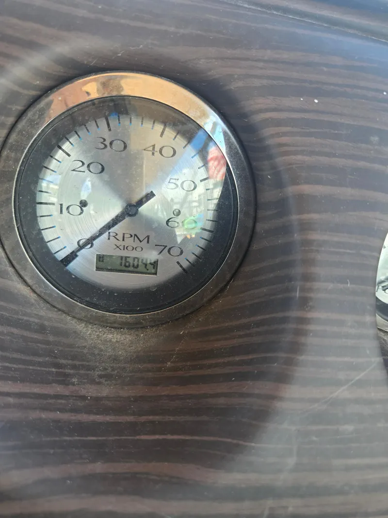 Slide: The Image of Close-up of a Bennington ETW 2019 RPM gauge displaying 1800 RPM on a wood-textured dashboard. - 9