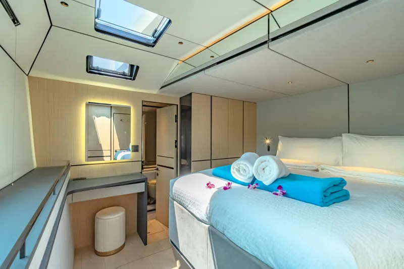 Slide: The Image of Luxurious McConaghy MC75 2026 yacht bedroom with skylights, modern decor, and plush bedding. - 11