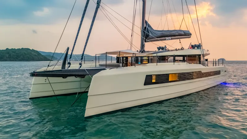Slide: The Image of 2026 McConaghy MC75 catamaran sailing on calm waters at sunset. - 23