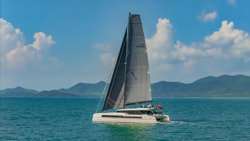 Slide: The Image of 2026 McConaghy MC75 sailing on a serene ocean with mountainous backdrop. - 24