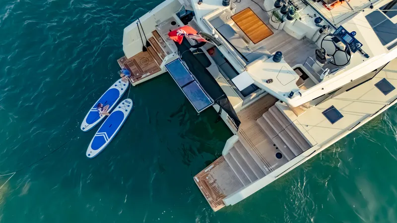 Slide: The Image of Aerial view of 2026 McConaghy MC75 yacht with paddleboards on turquoise water. - 4