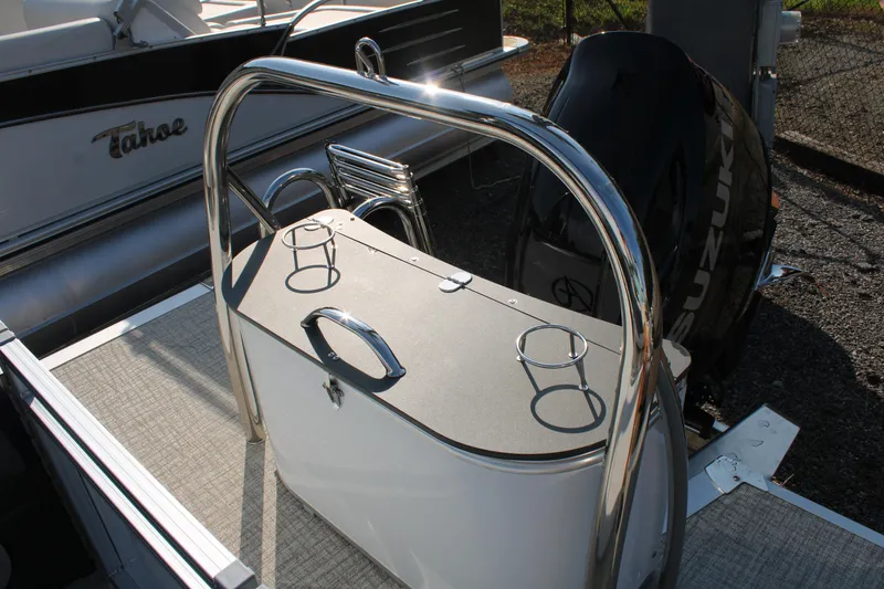 Slide: The Image of 2024 Avalon LSZ Quad Lounger boat with Suzuki engine and cup holders. - 12