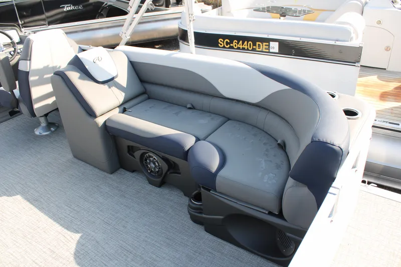 Slide: The Image of 2024 Avalon LSZ Quad Lounger boat interior with gray and blue seating. - 13