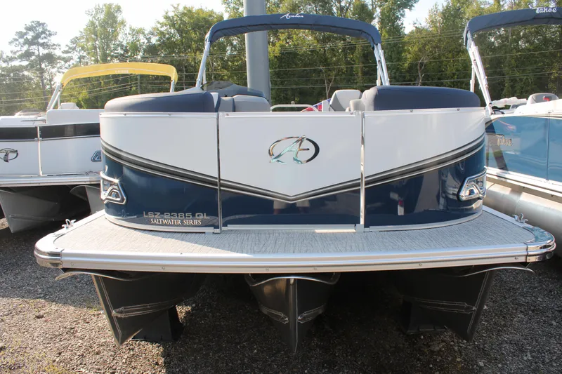 Slide: The Image of 2024 Avalon LSZ Quad Lounger pontoon boat, blue and white, parked outdoors. - 17
