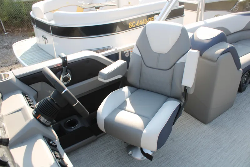 Slide: The Image of 2024 Avalon LSZ Quad Lounger boat interior with captain's chair and steering console. - 19