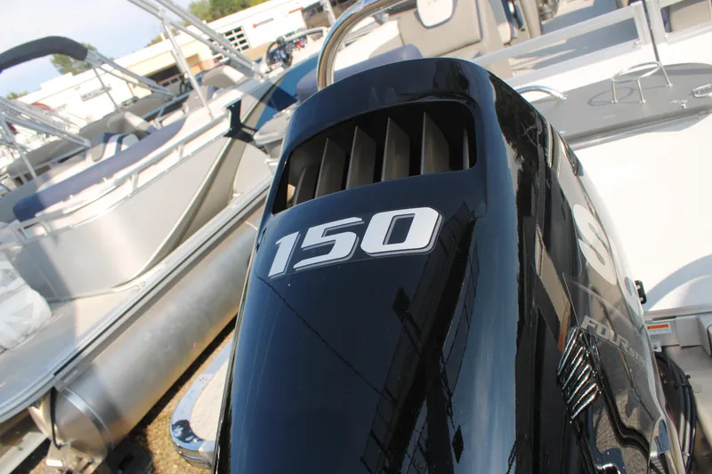 Slide: The Image of Outboard motor on 2024 Avalon LSZ Quad Lounger pontoon boat, featuring 150 horsepower. - 22