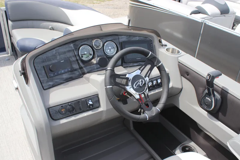 Slide: The Image of 2024 Avalon LSZ Quad Lounger boat dashboard with steering wheel and control panel. - 3