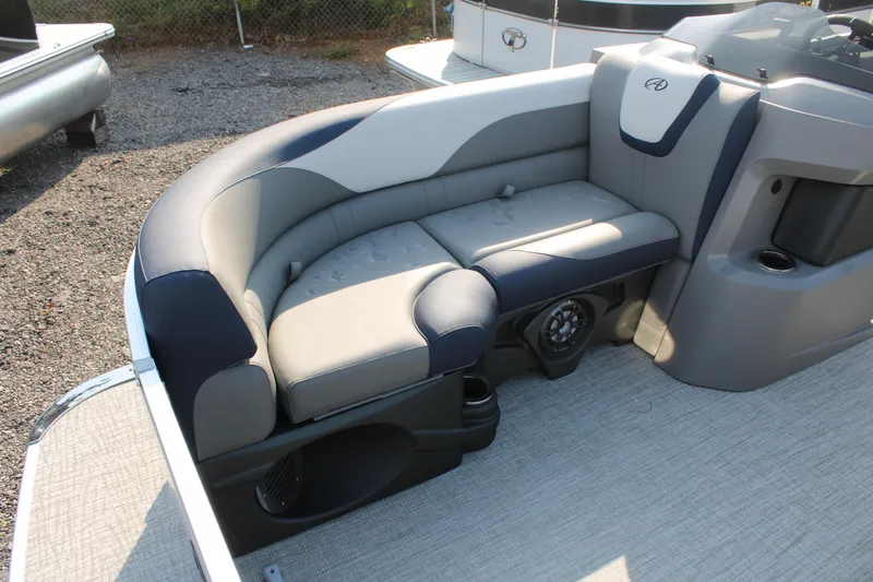 Slide: The Image of 2024 Avalon LSZ Quad Lounger boat seating with gray and navy upholstery. - 7