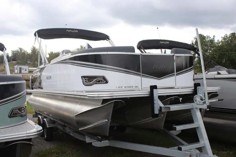 Slide: The Image of 2025 Avalon LSZ Quad Lounger pontoon boat on trailer, showcasing sleek design and modern features. - 15