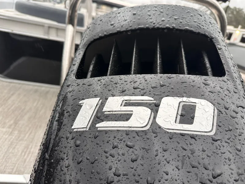 Slide: The Image of Close-up of a wet 150 horsepower engine on a 2025 Avalon LSZ Quad Lounger boat. - 9