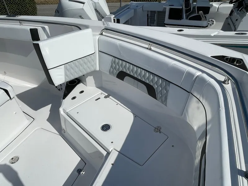 Slide: The Image of 2025 Blackfin 272CC boat interior with white seating and storage compartments. - 14