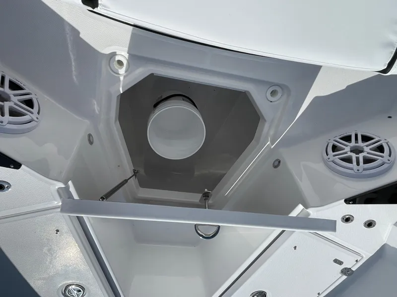 Slide: The Image of 2025 Blackfin 272CC boat interior storage compartment with speakers and white finish. - 18