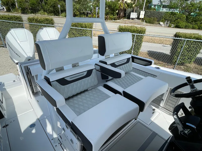 Slide: The Image of 2025 Blackfin 272CC boat interior with white cushioned seating and modern design. - 27