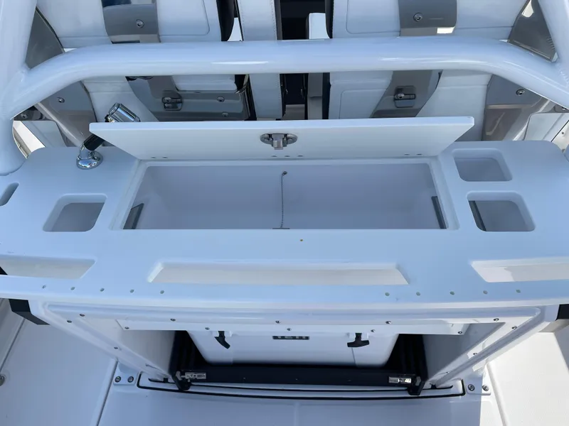 Slide: The Image of 2025 Blackfin 272CC boat console with storage and cup holders. - 32