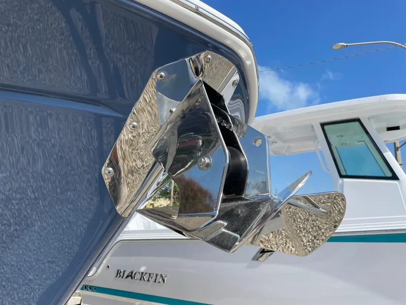 Slide: The Image of 2025 Blackfin 272CC boat with shiny anchor detail under clear blue sky. - 4