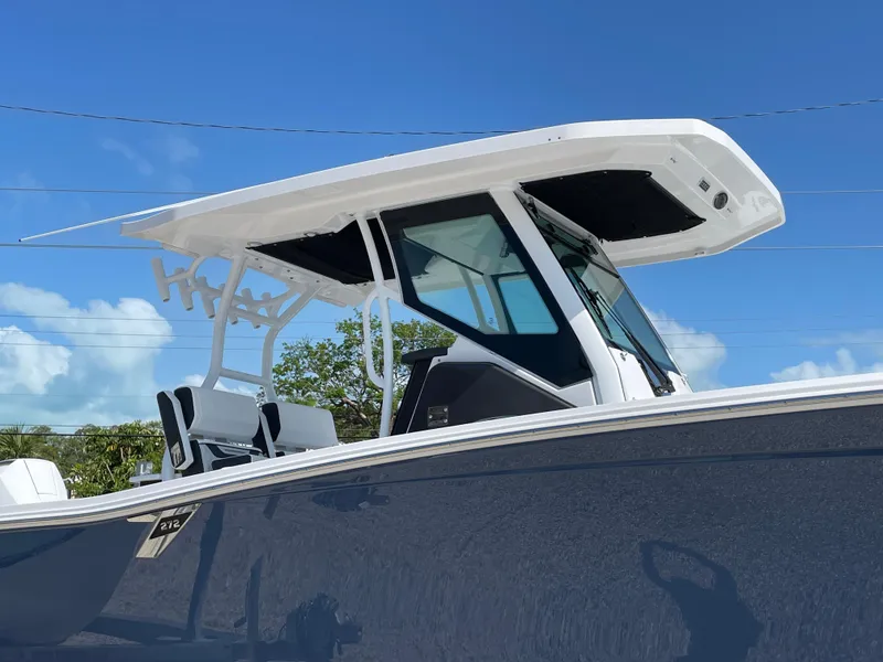 Slide: The Image of 2025 Blackfin 272CC boat with sleek design and modern features under a clear blue sky. - 40