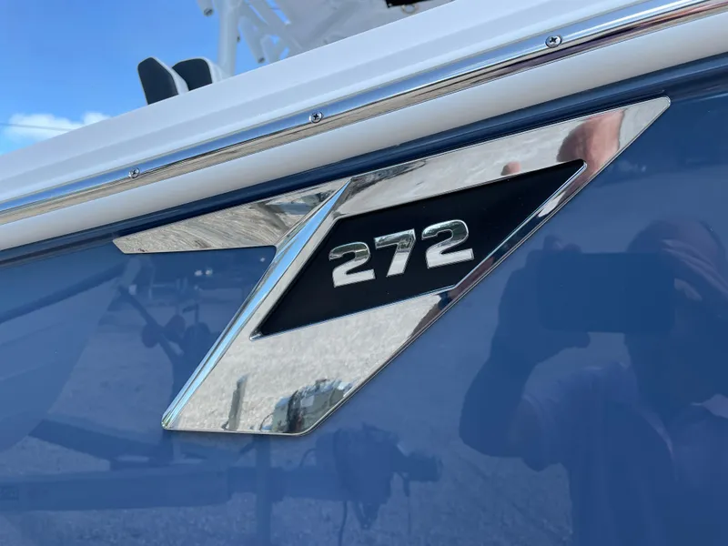 Slide: The Image of 2025 Blackfin 272CC boat emblem on a sleek blue surface. - 6