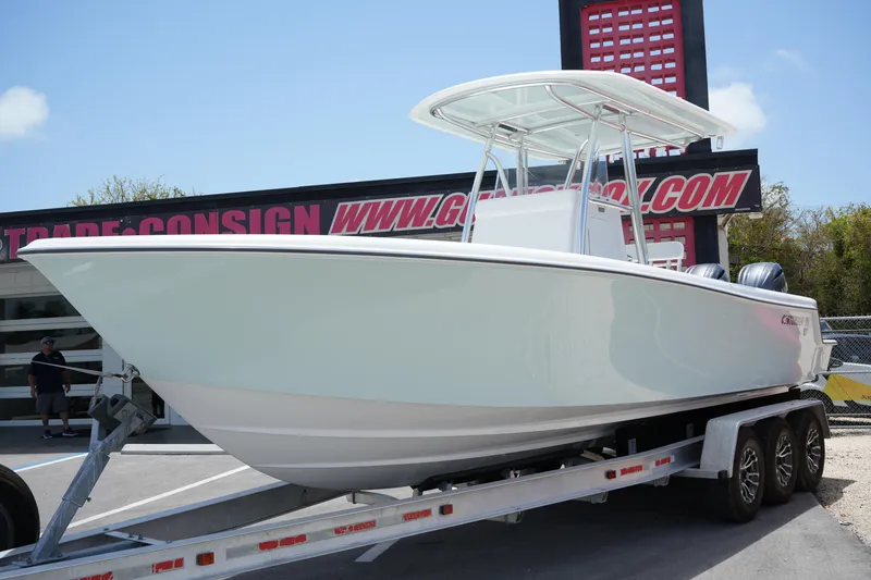 Slide: The Image of 2025 Contender 28T boat on trailer, displayed outdoors at dealership. - 1