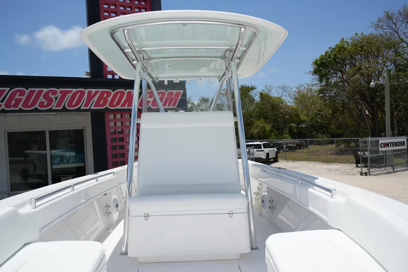 Slide: The Image of 2025 Contender 28T boat with sleek white seating and T-top, displayed outdoors. - 11