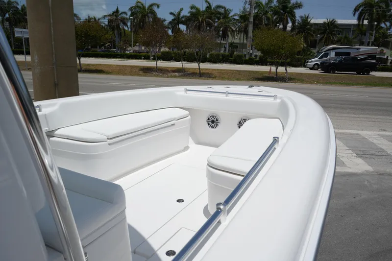 Slide: The Image of 2025 Contender 28T boat with sleek white seating and modern design. - 12