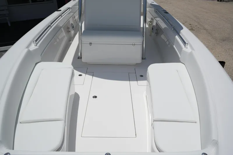 Slide: The Image of 2025 Contender 28T boat interior with white seating and storage compartments. - 13