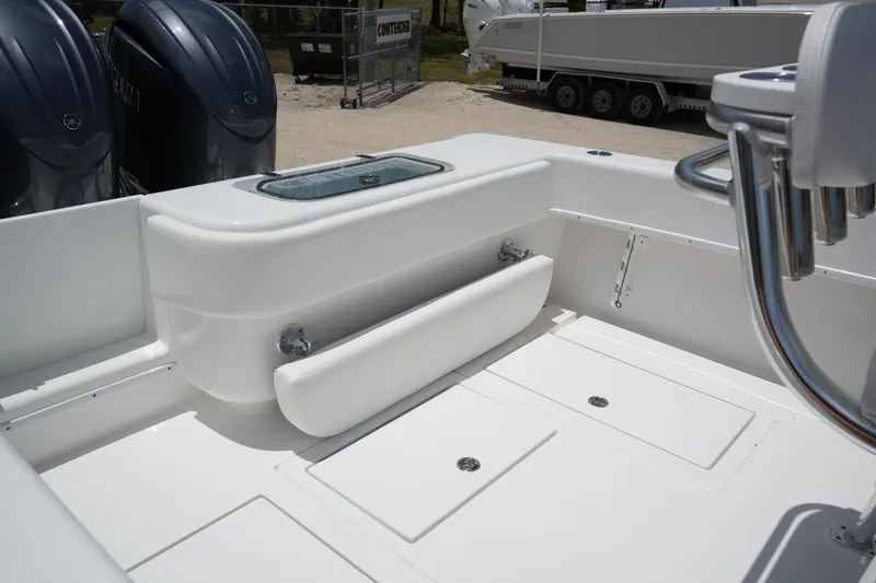 Slide: The Image of 2025 Contender 28T boat interior with storage compartments and dual engines. - 4
