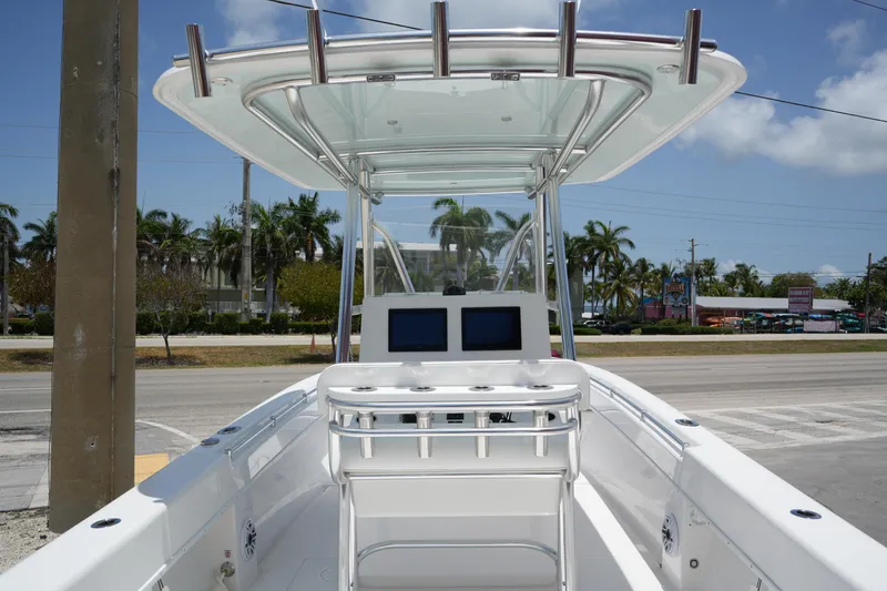 Slide: The Image of 2025 Contender 28T boat with T-top and dual screens, parked on a sunny street. - 5