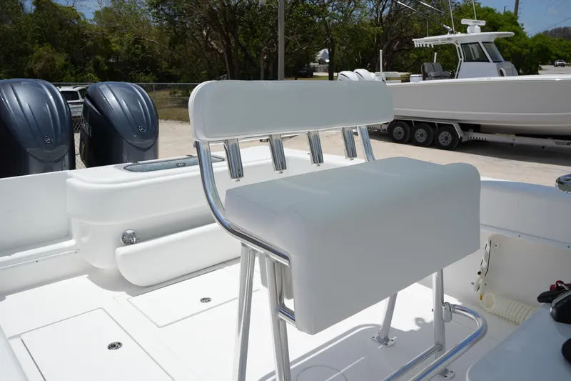 Slide: The Image of 2025 Contender 28T boat interior with white seating and dual outboard motors. - 6