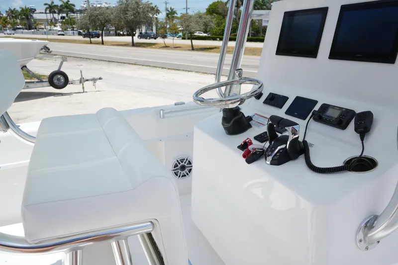 Slide: The Image of 2025 Contender 28T boat console with steering wheel, controls, and navigation screens. - 7