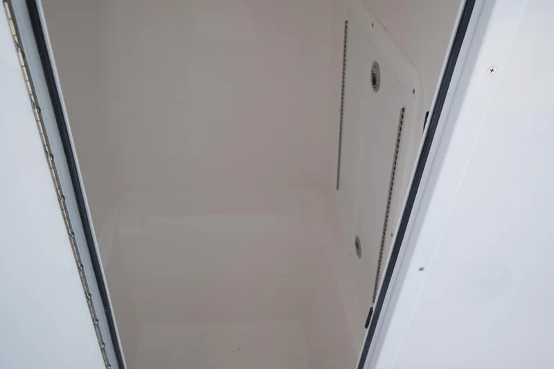 Slide: The Image of Storage compartment of 2025 Contender 28T boat, featuring a clean, spacious interior. - 9