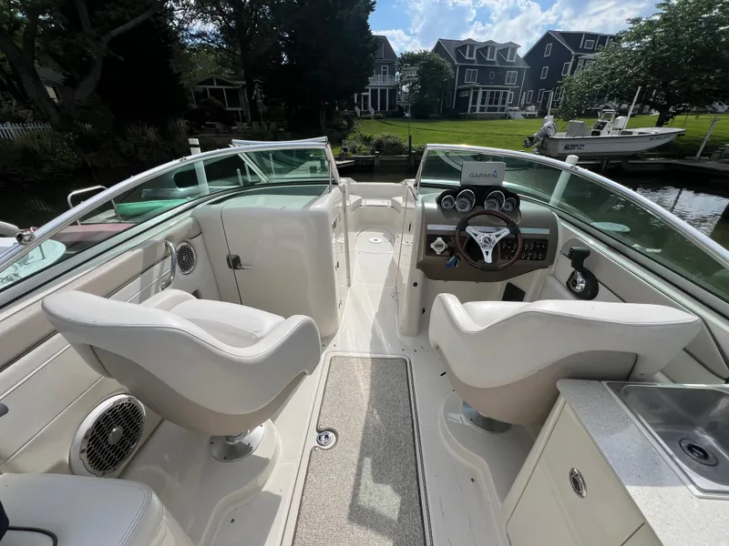 Slide: The Image of 2010 Sea Ray 280 Sundeck interior with helm, seating, and dashboard view. - 10