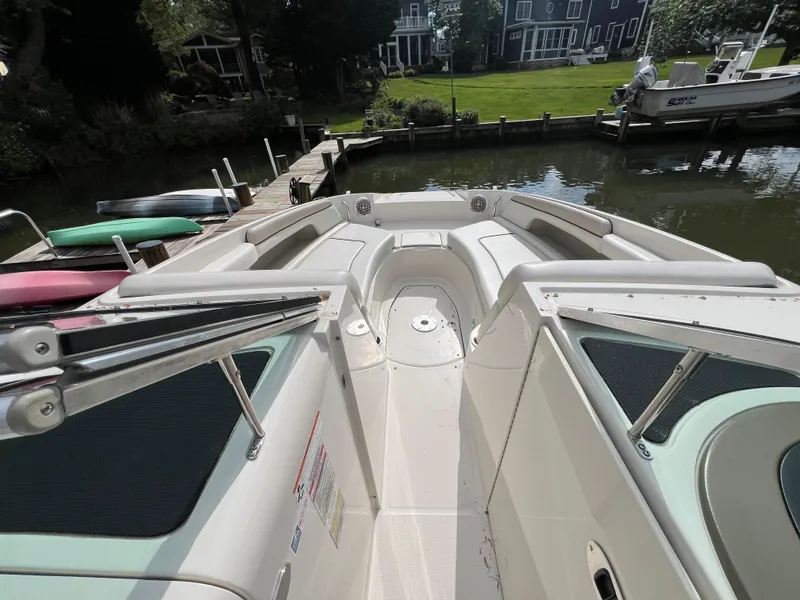 Slide: The Image of 2010 Sea Ray 280 Sundeck boat docked by a serene waterfront. - 14