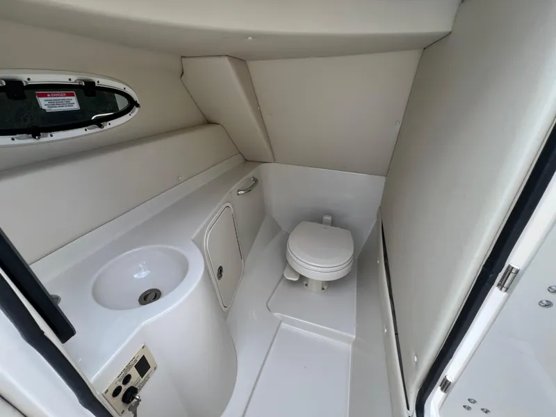 Slide: The Image of Interior of 2010 Sea Ray 280 Sundeck boat bathroom with sink and toilet. - 2