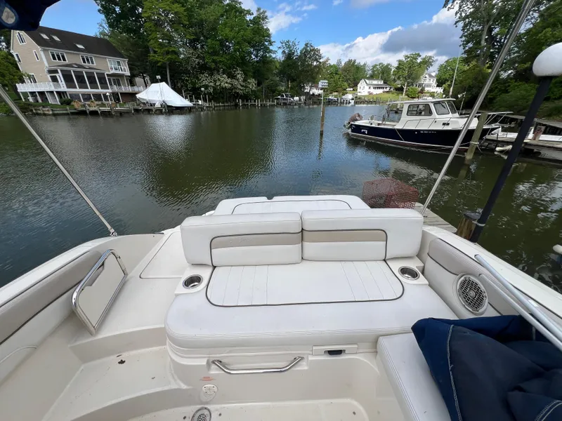 Slide: The Image of 2010 Sea Ray 280 Sundeck boat docked on a serene waterfront with lush greenery. - 20