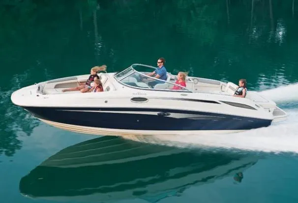 Slide: The Image of 2010 Sea Ray 280 Sundeck cruising on a serene lake with passengers enjoying the ride. - 25