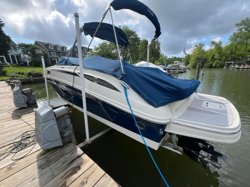 Slide: The Image of 2010 Sea Ray 280 Sundeck boat docked, covered with blue tarp, on a sunny day. - 4