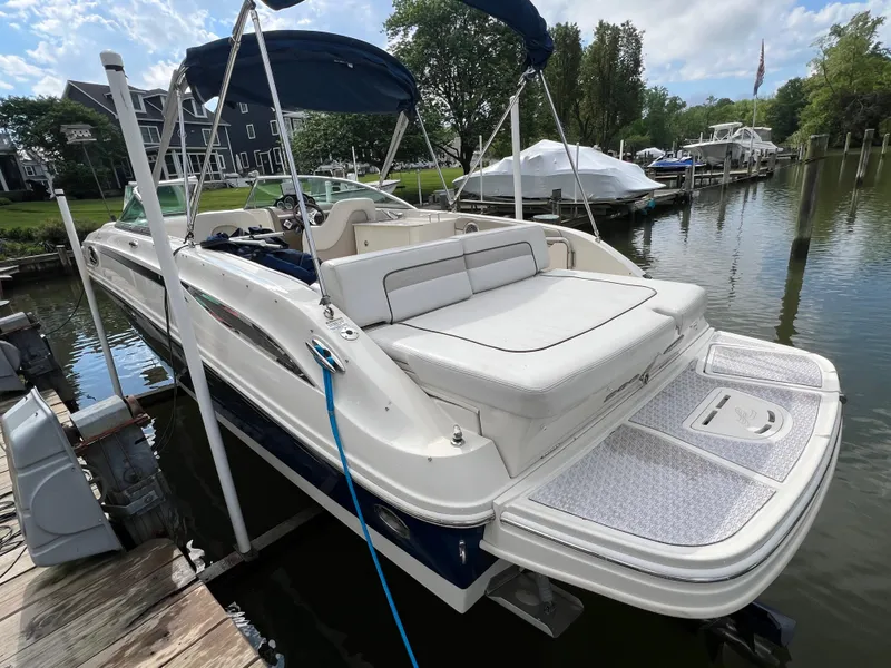 Slide: The Image of 2010 Sea Ray 280 Sundeck boat docked, featuring spacious seating and sleek design. - 6