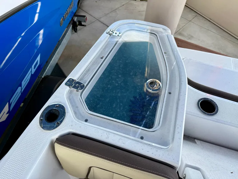 Slide: The Image of 2024 Yamaha Boats 255 FSH Sport H, featuring a sleek deck design with storage compartment. - 11