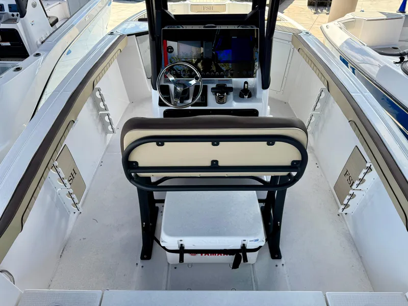 Slide: The Image of 2024 Yamaha Boats 255 FSH Sport H interior with helm and seating. - 2