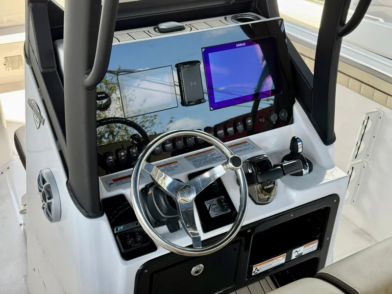 Slide: The Image of 2024 Yamaha Boats 255 FSH Sport H dashboard with steering wheel and digital display. - 3