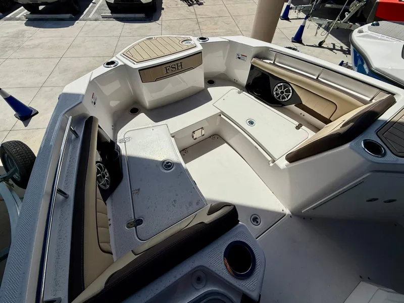 Slide: The Image of 2024 Yamaha Boats 255 FSH Sport H interior with seating and speakers. - 7