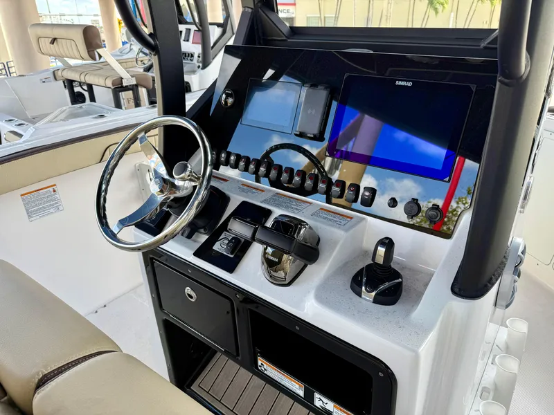 Slide: The Image of 2024 Yamaha Boats 255 FSH Sport H dashboard with steering wheel and control panel. - 9