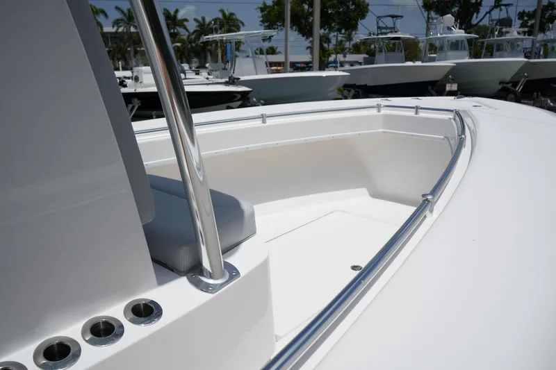 Slide: The Image of 2025 Contender 25T boat deck with stainless steel railings and rod holders. - 11