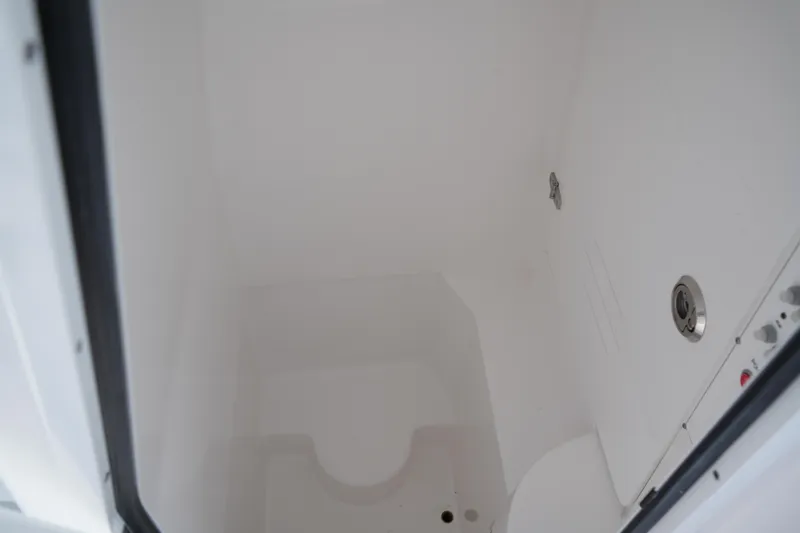 Slide: The Image of Interior view of 2025 Contender 25T boat compartment, featuring a clean, white finish. - 12
