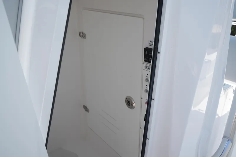 Slide: The Image of 2025 Contender 25T boat interior cabin door, white and sleek design. - 13