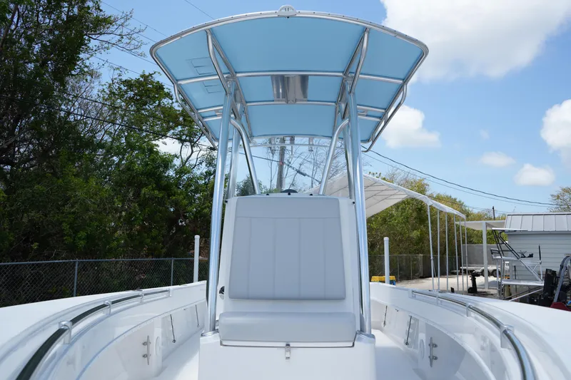 Slide: The Image of 2025 Contender 25T boat with T-top, white seating, and clear blue sky background. - 15