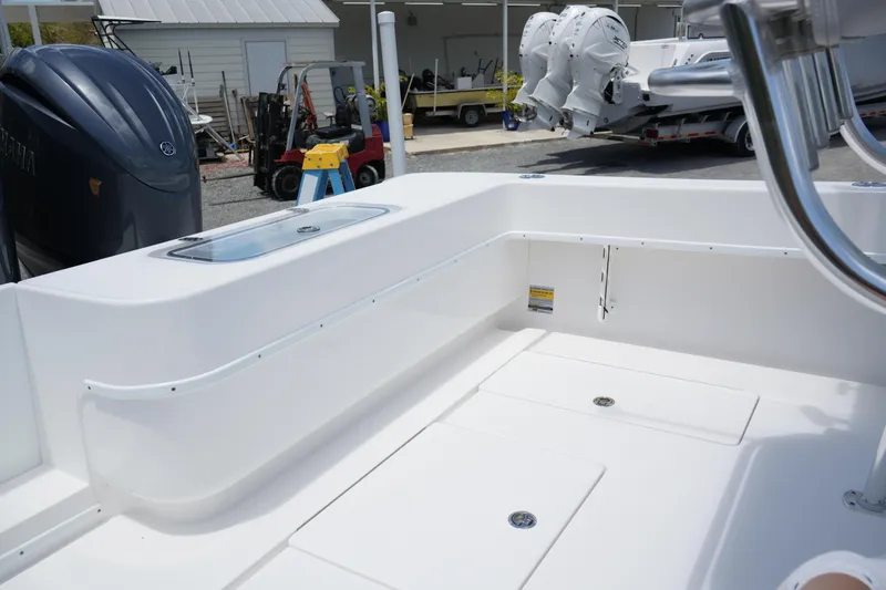 Slide: The Image of 2025 Contender 25T boat interior with white seating and storage compartments. - 4